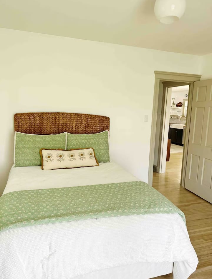 Guest room with double bed, corner full length mirror and closet space. 