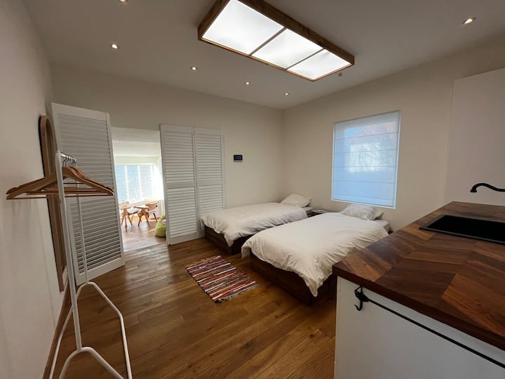 Спалня на долния етаж със самостоятелна баня и допълнителна зона за игра/ бюро