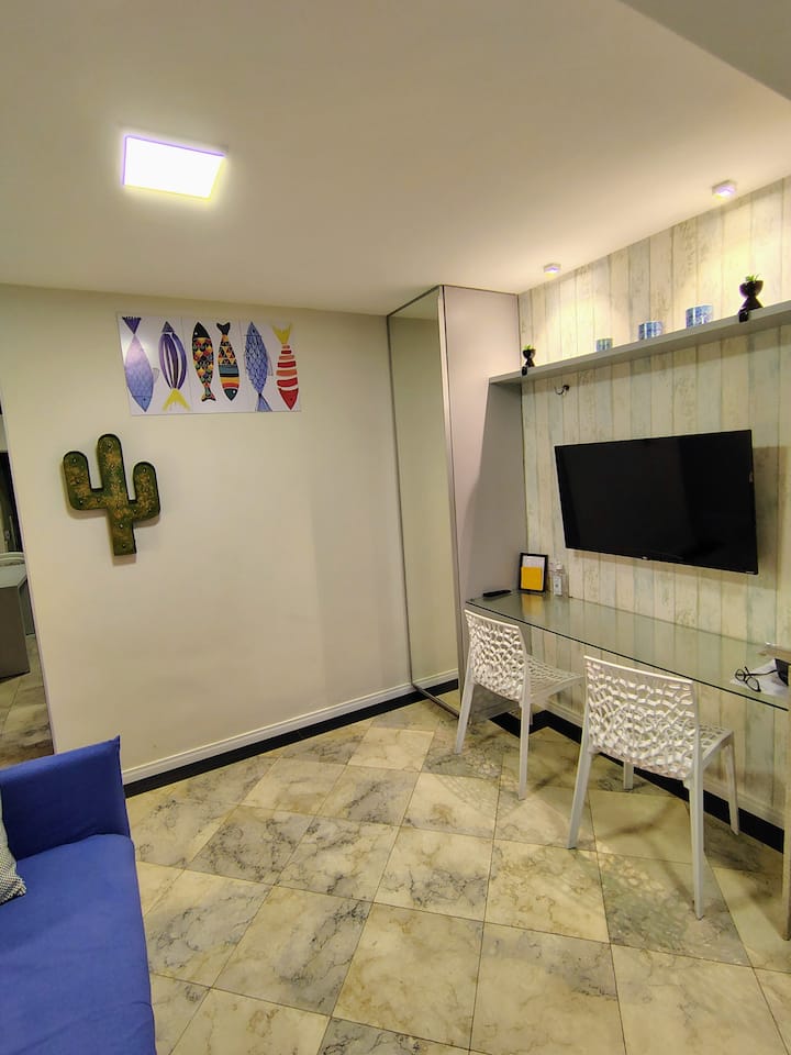 The living room is combined with the kitchen and separated from the bedroom by a hallway and door.