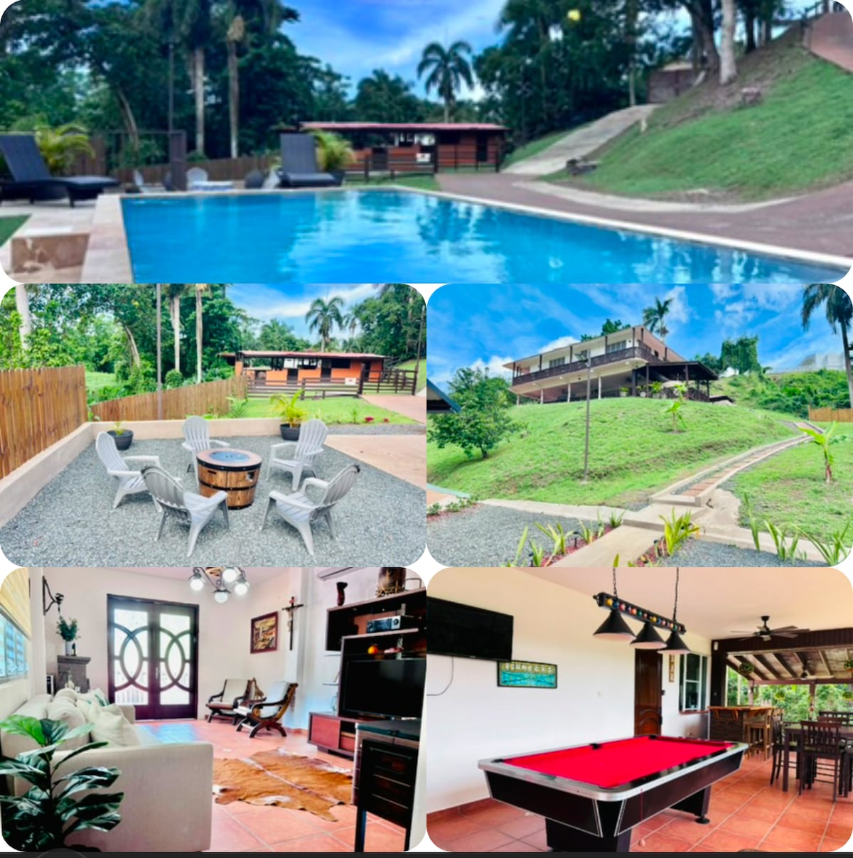 A serene outdoor area features a sparkling pool surrounded by sun loungers and lush greenery. Nearby, a fire pit area with seating invites relaxation. In the background, the hacienda stands on a hill, complementing the landscape with rustic charm. Inside, the living room showcases comfortable furniture and entertainment options, while an adjacent terrace includes a pool table, enhancing the recreational experience.