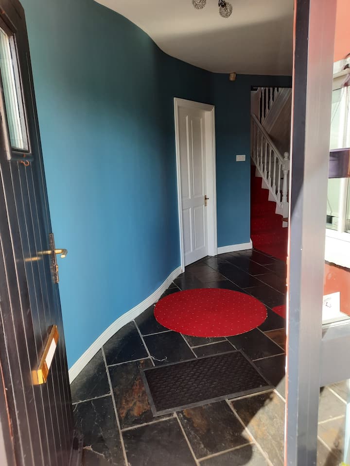 Your room is the white door on your left as you enter Front door. 