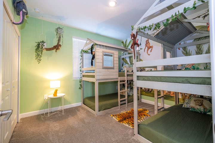 Bedroom 4: Safari-Themed Kids’ Room featuring two twin bunk beds, playful decor, and a fun, adventurous atmosphere for young explorers.