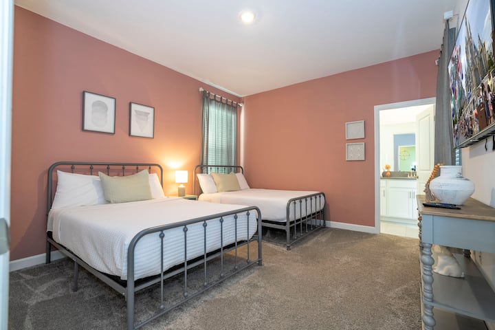 Bedroom 2: Two full-size beds, Smart TV, and private bathroom