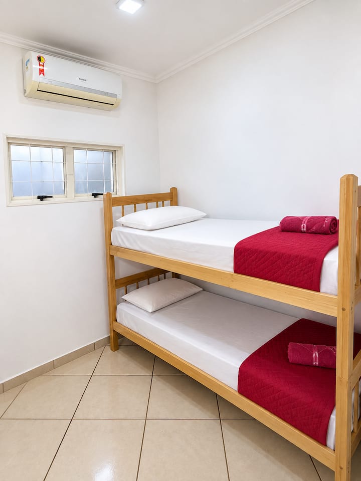Quarto com Ar condicionado, beliche com colchões DE, lençóis e fronhas de algodão, cobertores e toalhas.