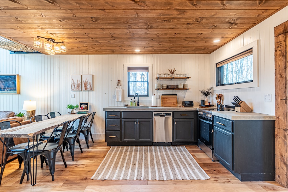 The Overstory — Full kitchen and dining area with a dishwasher and oven.