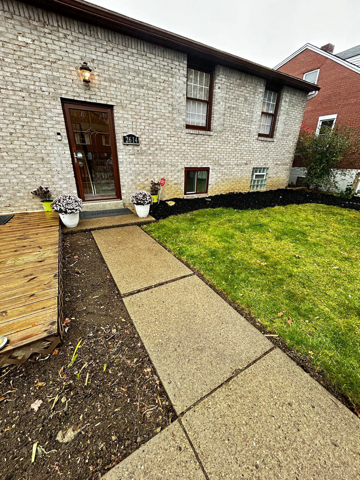 Exterior — brick house, lawn, deck