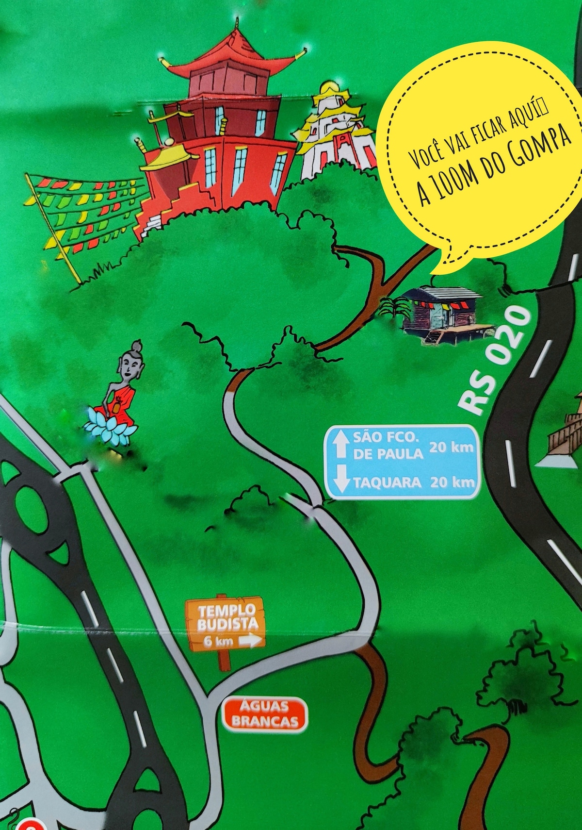 A colorful map highlights surrounding attractions, including Buddhist temples and natural areas. Clear directional signs indicate distances to nearby locations, such as São Fco and Taquara. The map is designed with green and vibrant tones, providing an easy reference for guests exploring the region.