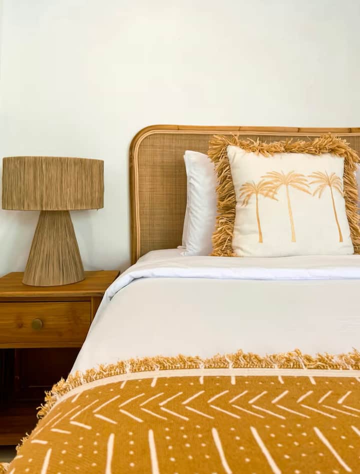 Bedroom 2 opens directly to the pool, offering stunning views and a luxurious, minimalist interior. With stylish decor and seamless pool access, it’s designed for comfort and relaxation in a serene, sophisticated setting.