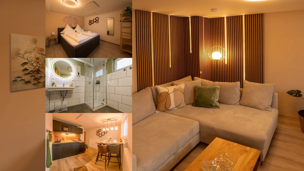 A cozy living space features a spacious sectional sofa positioned around a wooden coffee table. A well-lit modern kitchen is visible, showcasing an inviting dining area for four. The bedroom presents a large bed with soft linens. A contemporary bathroom offers a stylish shower.