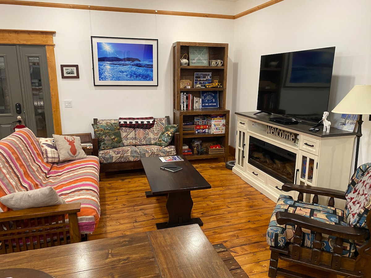 Comfortable seating area with fireplace and games. Futon is a three seat sofa and converts to a double bed for sleeping. Smart TV with many apps including DAZN with included Game Pass to watch NFL games. Electric Fireplace and games cupboard.