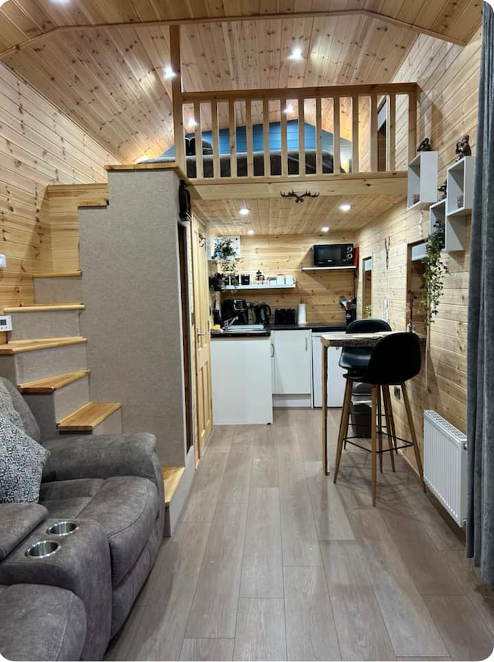 The staircase, a striking feature, is not your typical set of stairs; it's a bespoke design that adds character and functionality to the the cabi ,which requires a certain level of mobility, including the ability to comfortably navigate stairs.