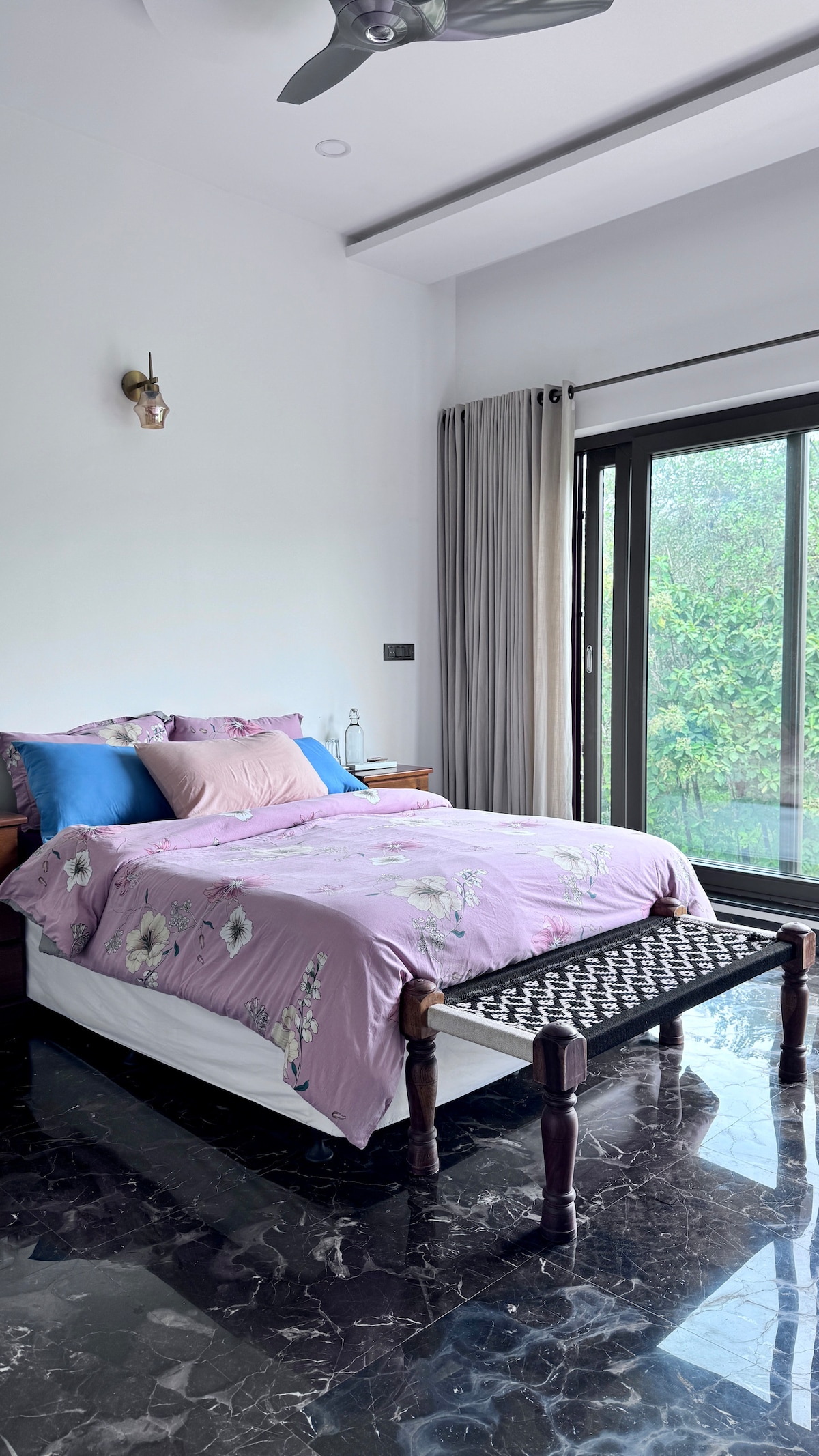 A cozy bedroom with queen-size bed facing just nature, kudremukh hills in the background and lush green cover, right infront of the room until the view of hills