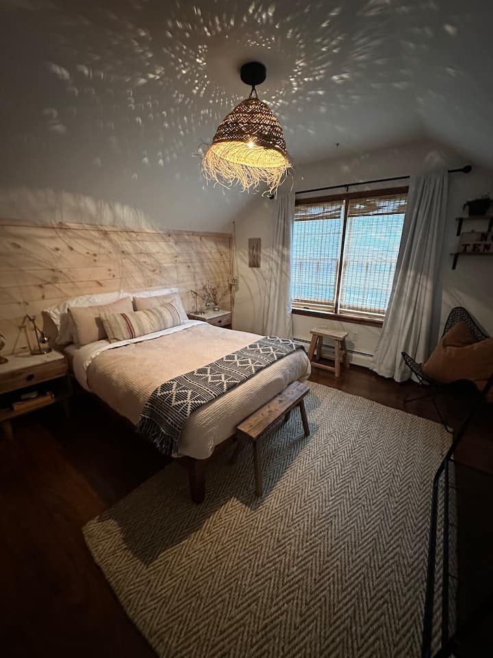 One of the smaller bedrooms featuring a full size bed. Still plenty of room for chairs and sitting or a twin size air mattress. This room overlooks the front yard and street. Very cozy!