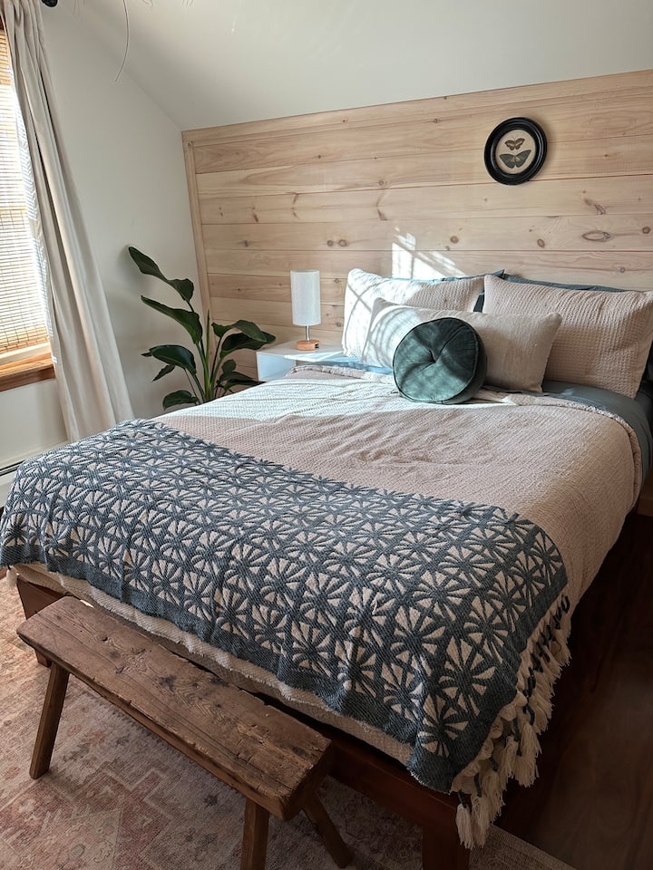 This is the other smaller bedroom directly across from its twin. This room overlooks the pool patio and features a full size bed as well. Another quaint and cozy space. 