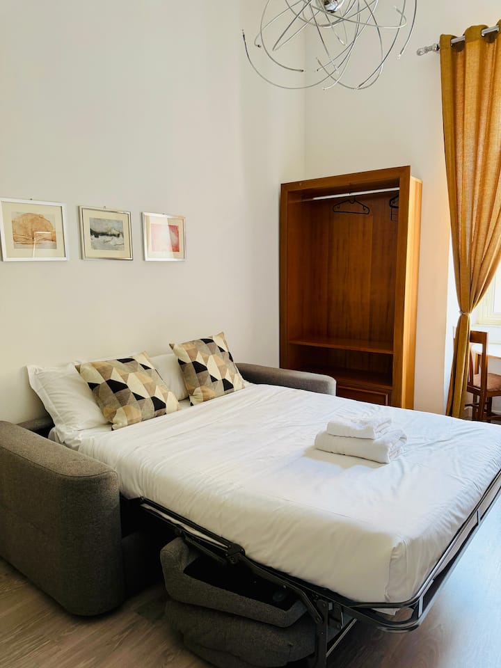 Large living room with comfortable sofa bed for two (18mm Memory mattress), 43"HD TV, extendable dining table and wardrobes.