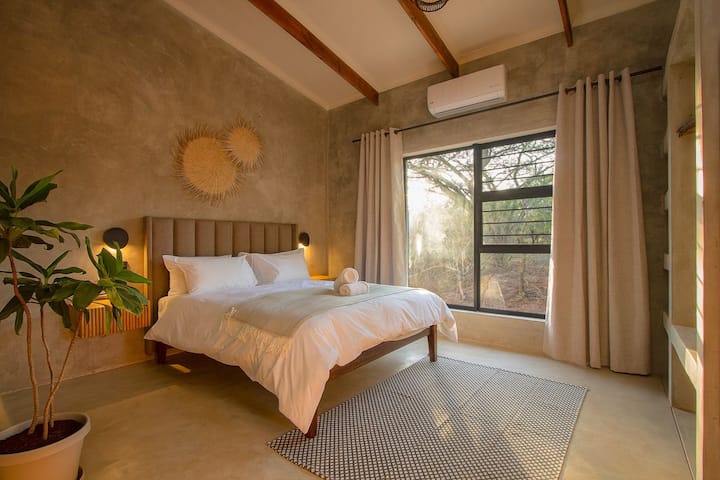 Luxurious 2nd Bedroom With Ample Closet Space & Luxury Bedding Overlooking The Surrounding Bushveld.