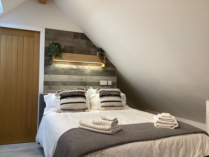 There is a split light above the bed, so each side can be switched on or off. Charging points for electronic devices are also on the wall. Hanging space is behind the bed in alcove, which also has a light.Please mind your head on the sloped ceiling. 