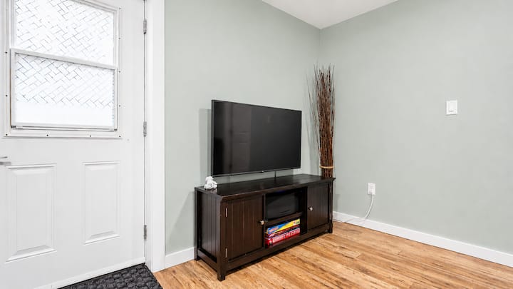The TV in the living room. The cabinet under it is full of board games suitable for all ages. The door pictured is the entrance to the suite.