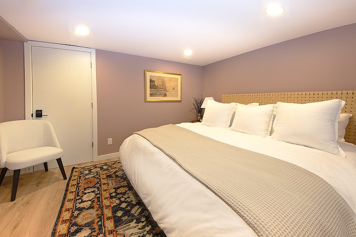Private lower-level bedroom with comfortable bedding and an attached ¾ bathroom.