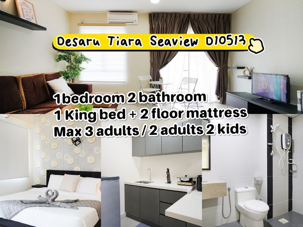 The spacious living area includes a comfortable sofa, a dining table, and a television. The kitchen features modern appliances and essential cooking utensils. The bedroom showcases a king-size bed with additional floor mattresses. Two bathrooms provide convenience for guests.