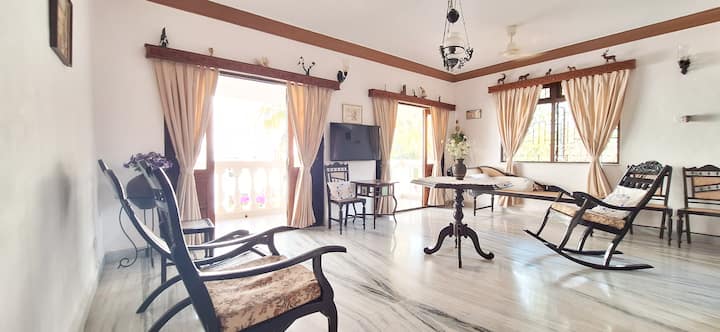 Experience the charm of a traditional Goan-inspired living room filled with natural light from its many windows and complemented by a spacious sit-out balcony.