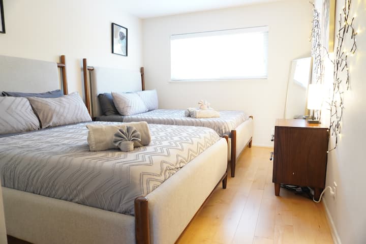 - Spacious twin-bed room with soft neutral bedding  
- Minimalist design with glowing fairy lights and mirror  
- Perfect stay for group travelers wanting modern comfort  
