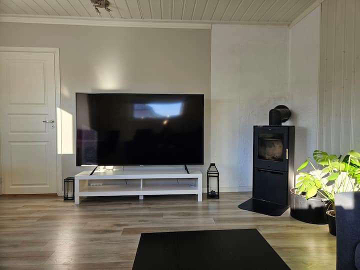 Голям телевизор от 75 инча във всекидневната. 