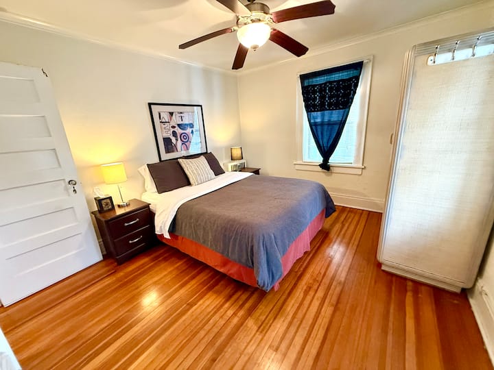 Queen size bed with some storage room in the armoire.