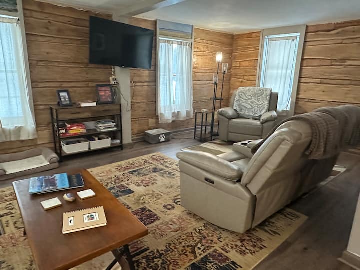This portion is the original log cabin. Built in 1890 and moved to its current location in 1920. The cedar was cut from original forest growth. Count the rings, if you can! Watch a show, play a game, read a book or just relax. Feel the history!