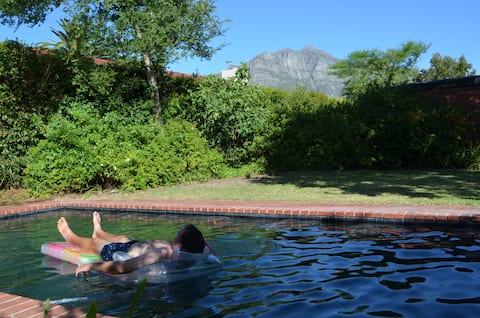 Retro Red Stone Villa with pool & lush garden