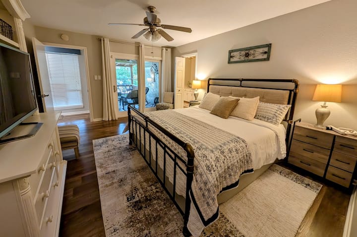 Your private oasis awaits in the spacious master bedroom. Sink into the king-size bed with extra mattress toppers, relax in the seating area, enjoy Roku on the TV, and easily access the patio. (Air mattress available.)