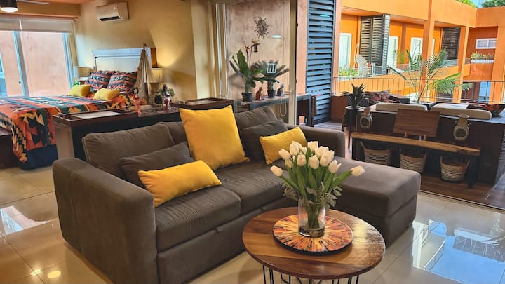 Settle into a bright, inviting living room that connects the king bedroom and private balcony. Stretch out on the chaise, enjoy morning coffee among the flowers, or unwind together after a day in Puerto Vallarta.
