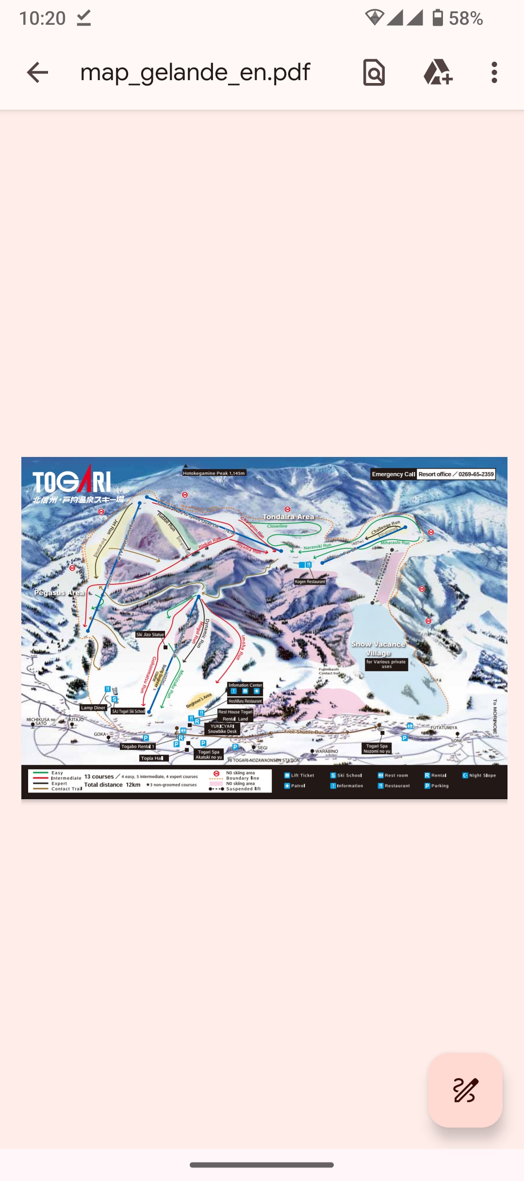 A detailed ski resort map is displayed, illustrating the various trails and lifts at Togari Onsen Ski Area. Color-coded routes indicate difficulty levels, while relevant symbols mark facilities and services. The snow-covered mountains provide a scenic backdrop, emphasizing the area's winter sports offerings.