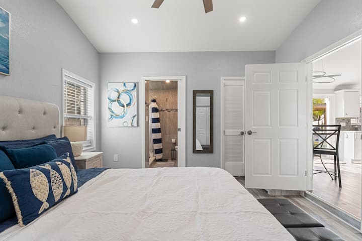 Spacious king bedroom with a comfortable layout and convenient access to the private bathroom.