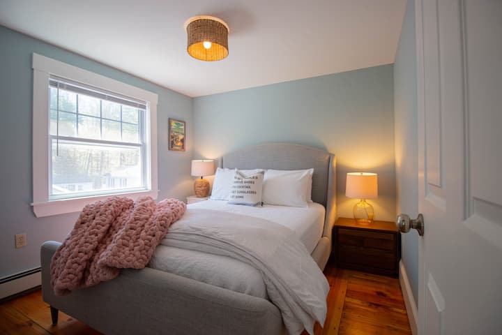 Comfortable queen bed with plush bedding, cozy linens, and plenty of pillows.