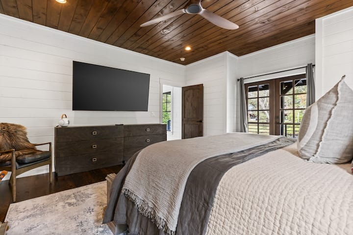 Master Bedroom: Stylish retreat with rich wood accents and stunning views to rejuvenate your stay!