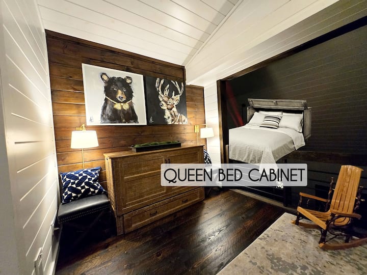 Queen Bed Cabinet: Unique charm awaits with artwork, rustic decor, and inviting lighting!