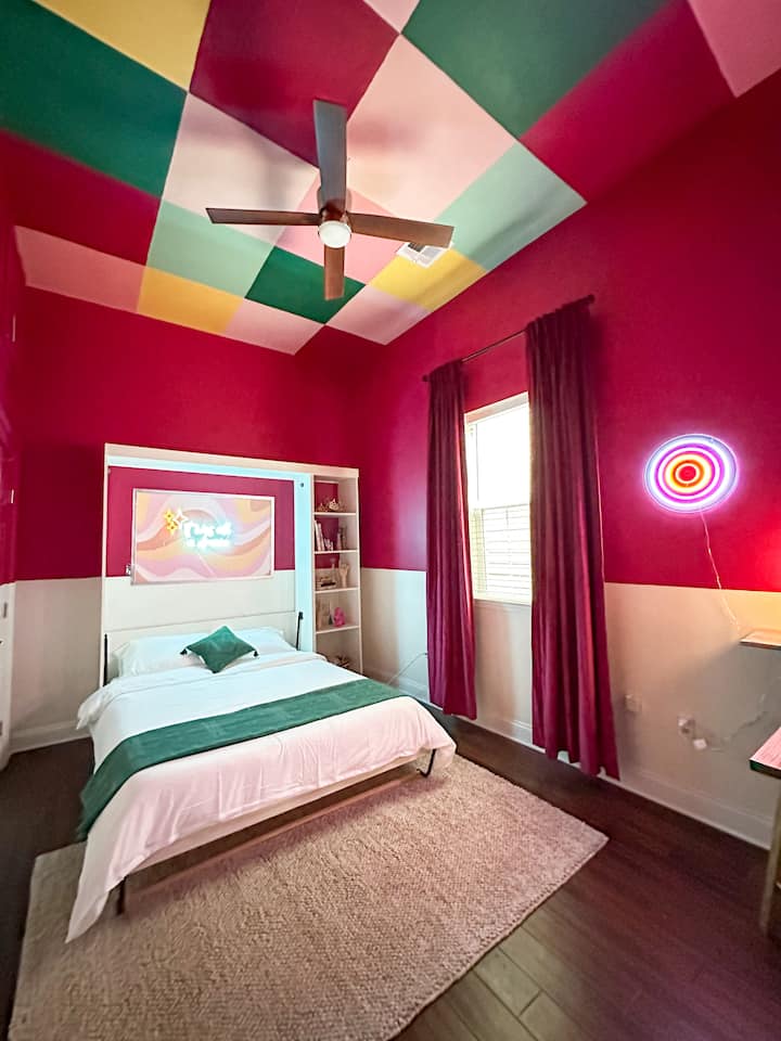 Transform this bedroom into your own personal "New Orleans at Night" space! 

Disco elements, neon signs, and a vintage inspired vanity & working space make this space ideal for all guests of any ages! Baby gate available. 