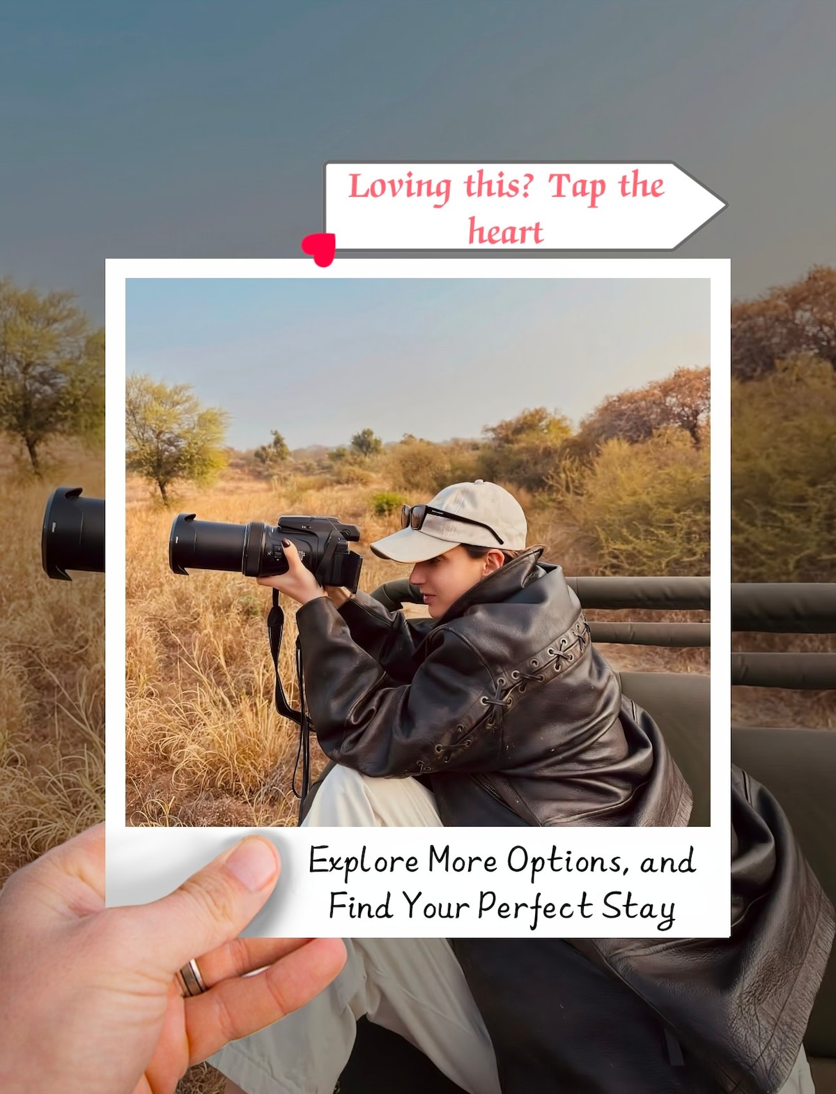 A person is captured while photographing wildlife, seated in a safari vehicle surrounded by tall grass and bushes typical of a natural reserve. The landscape features a blend of earthy tones and foliage, suggesting an immersive outdoor experience.