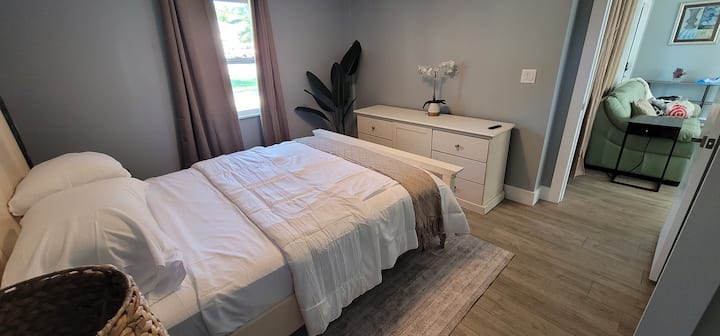 Queen bed with attached bathroom and walk-in closet, main house