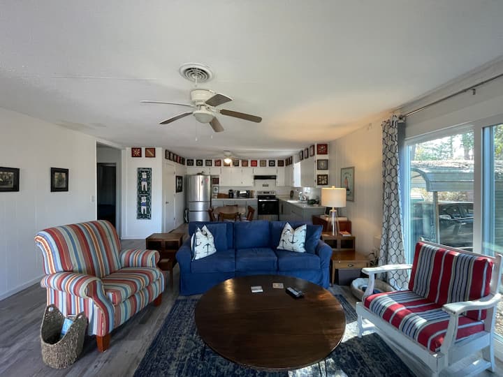 Le salon comprend un canapé convertible avec un canapé-lit, une chaise, un fauteuil inclinable et un basculeur. Deux portes vitrées coulissantes offrent une vue sur la rivière et beaucoup de lumière naturelle. 