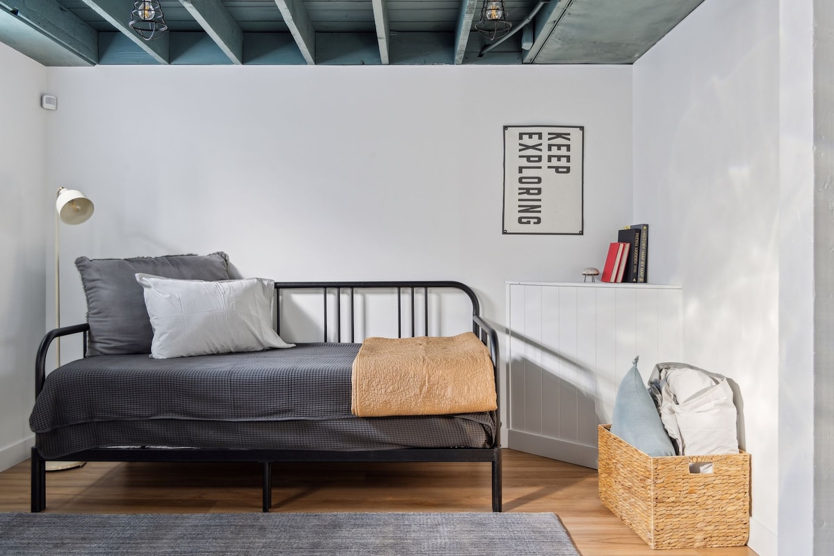 The basement features a nice family room with a daybed, smart TV, bathroom and a private bedroom. 