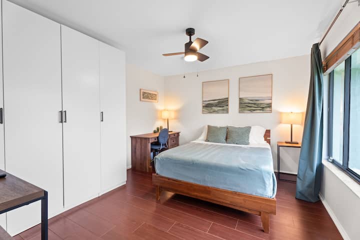 The fourth bedroom, located near the kitchen, offers a queen memory foam bed, desk, closet, and TV. Ceiling fan and light operate by pull strings—just make sure the wall switch is on.