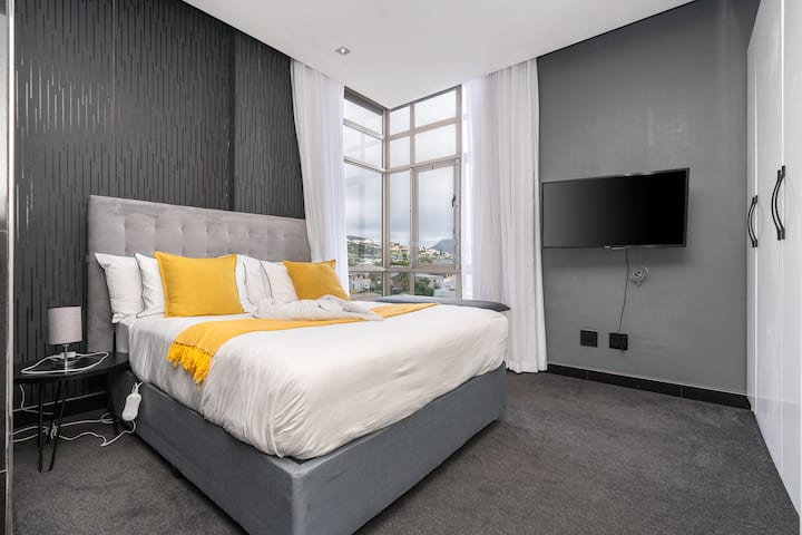 Serene Master Bedroom: Experience a chic retreat featuring stunning views and elegant decor, creating a stylish and comfortable space perfect for relaxing and enjoying your stay.