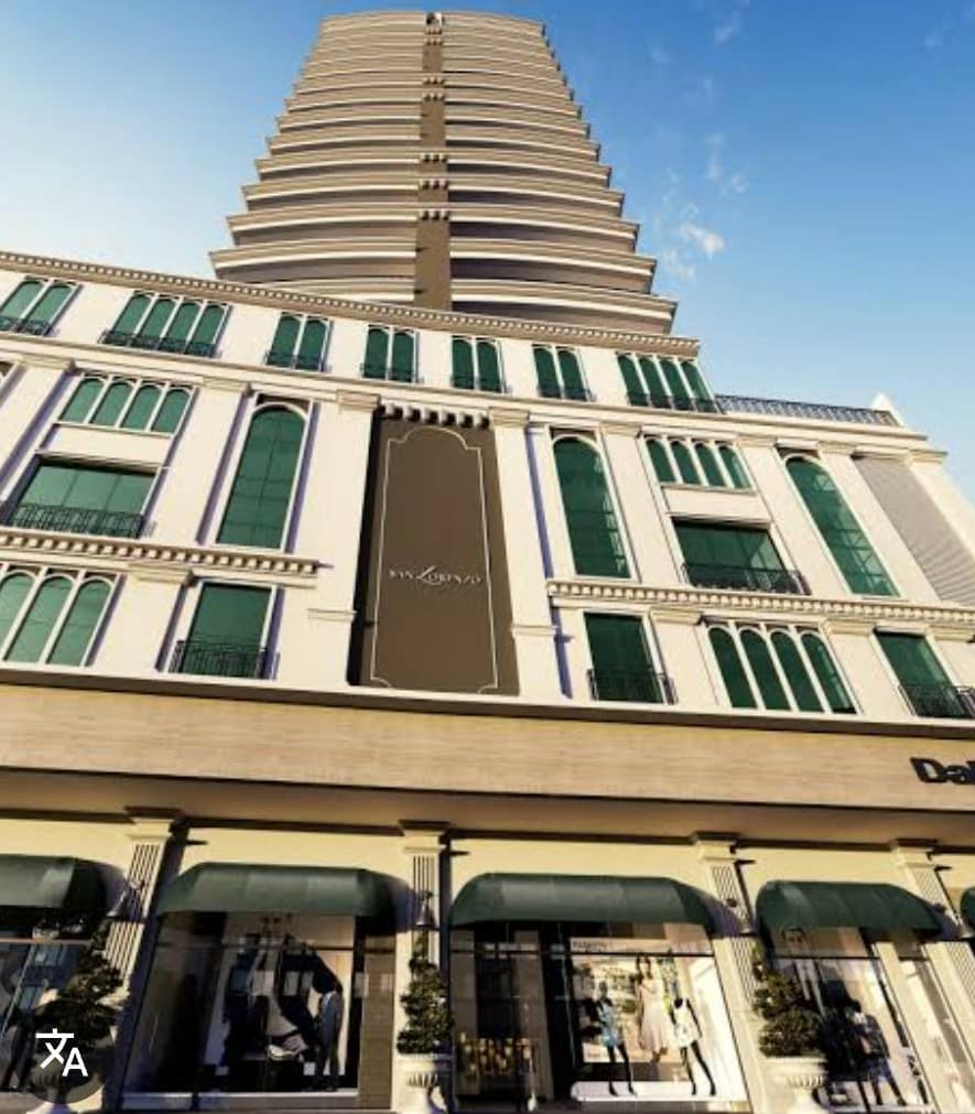 A modern multi-story building is highlighted, featuring a blend of classic and contemporary architectural styles. Large windows with green accents adorn the facade, while storefronts with awnings line the ground level, providing a vibrant urban atmosphere.