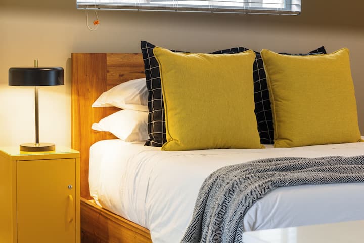 Cozy queen-size bed with plush linens for a restful stay.