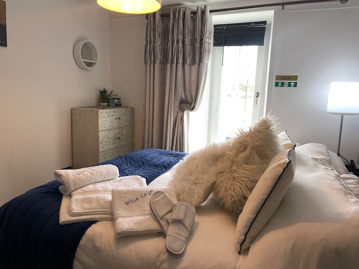 The downstairs bedroom provides a comfortable and inviting atmosphere, complete with an ample supply of towels, house coats, and slippers for your convenience.