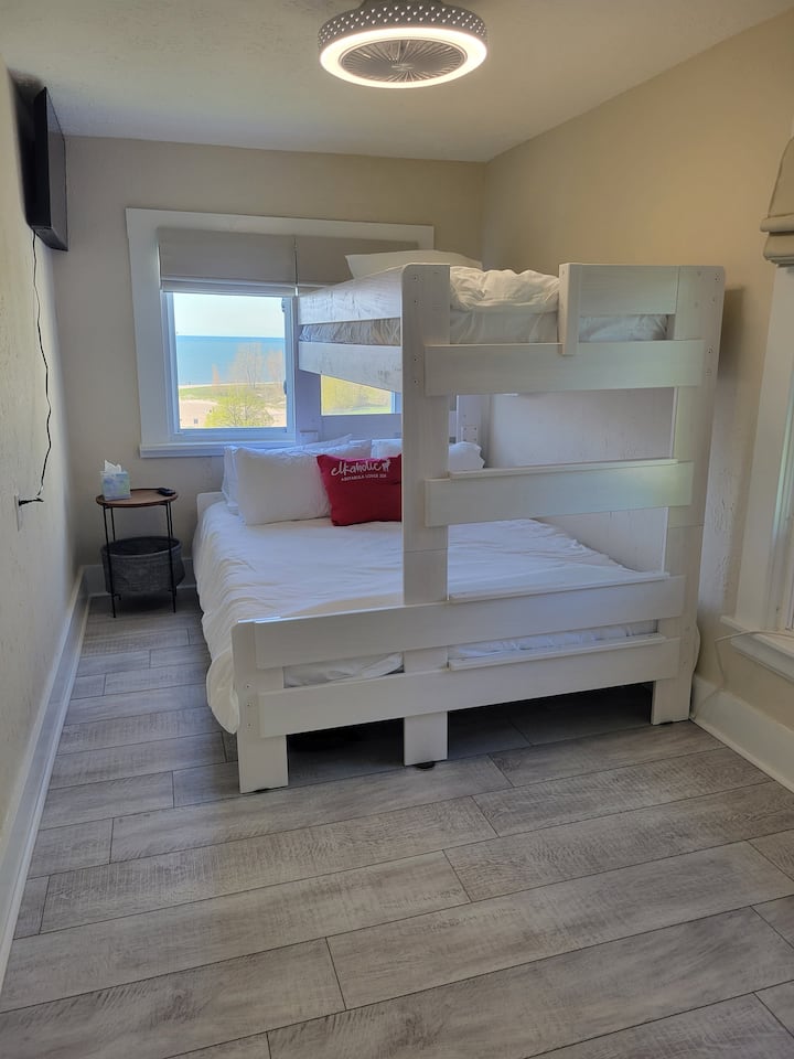 Cozy up in this 2nd floor bedroom featuring a twin XL over queen bunk. This room sleeps 3 and has a closet, luggage rack and 40" smart TV.