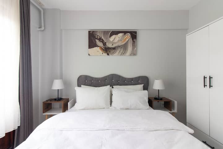 Uredna i mirna spavaća soba s bračnim krevetom.