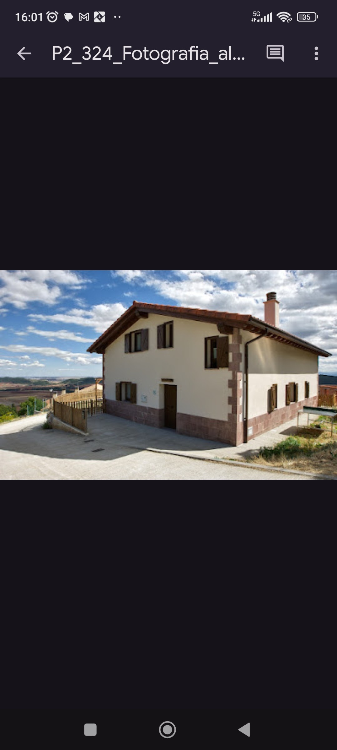 A charming two-story rural house is depicted, showcasing a light-colored exterior with wooden accents. Large windows provide ample natural light, while a welcoming driveway leads up to the entrance. The surrounding landscape features rolling hills under a partly cloudy sky.